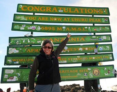 Karen at the summit sign