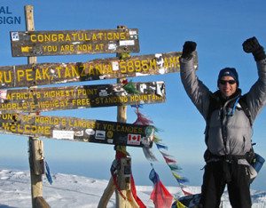 Trekker with Kilimanjaro's original summit sign
