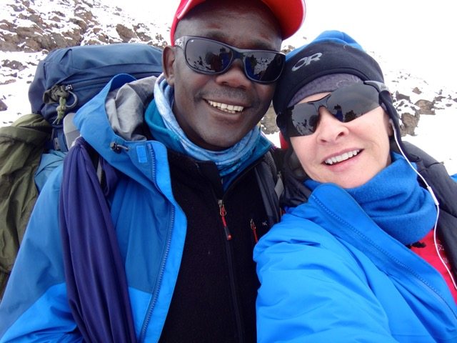 Laurel W. poses with a guide on the snowy trail