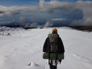 Trekker looks out into the vast expanse of Kilimanjaro