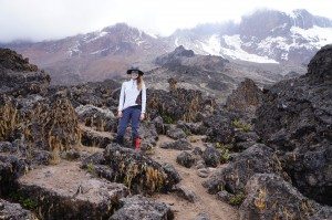 Natalie H. poses in one of KIlimanjaro's rocky areas