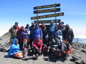 Patrick S. and his trekking party pose at Uhuru peak