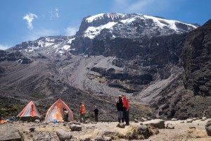Tented camps against Kilimanjaro's rocky outcroppings