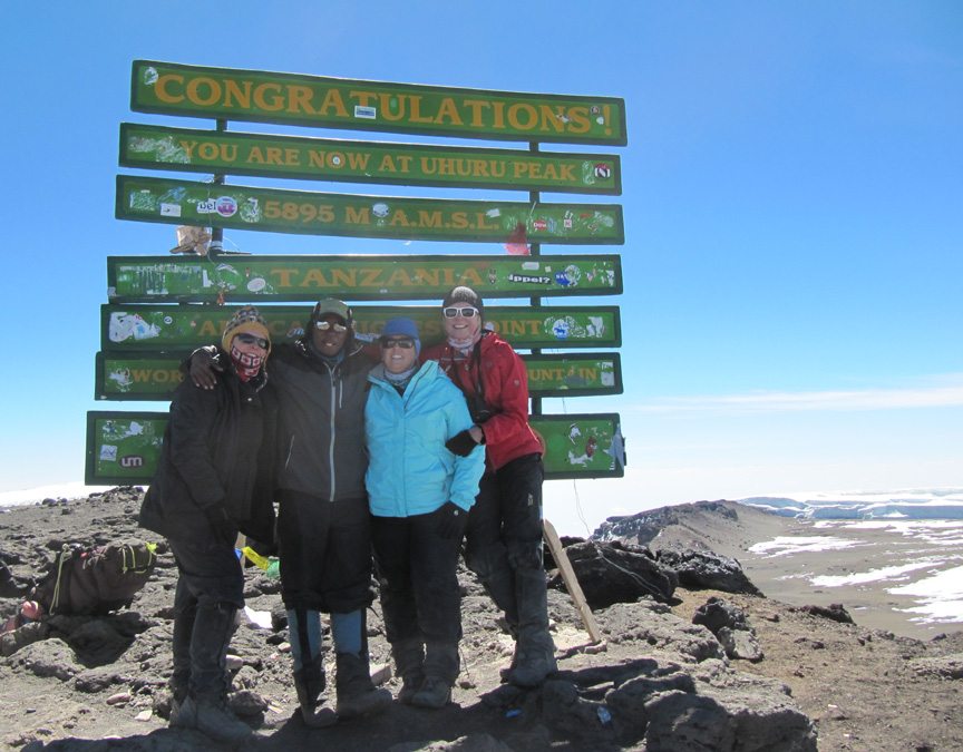 Kelly W. with guides and friends at Uhuru peak