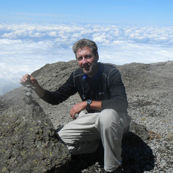 Bernie G. poses with a rock formation on Kilimanjaro