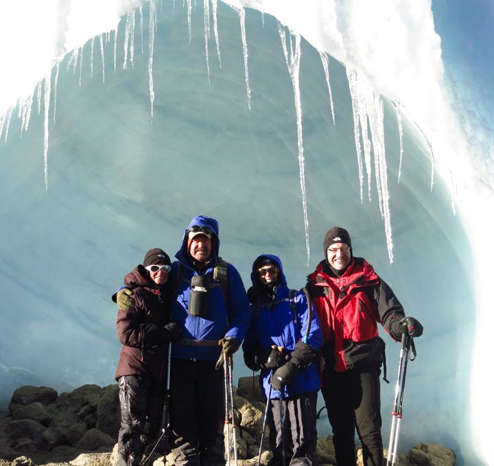 Iris B. and John M. pose with a glacier