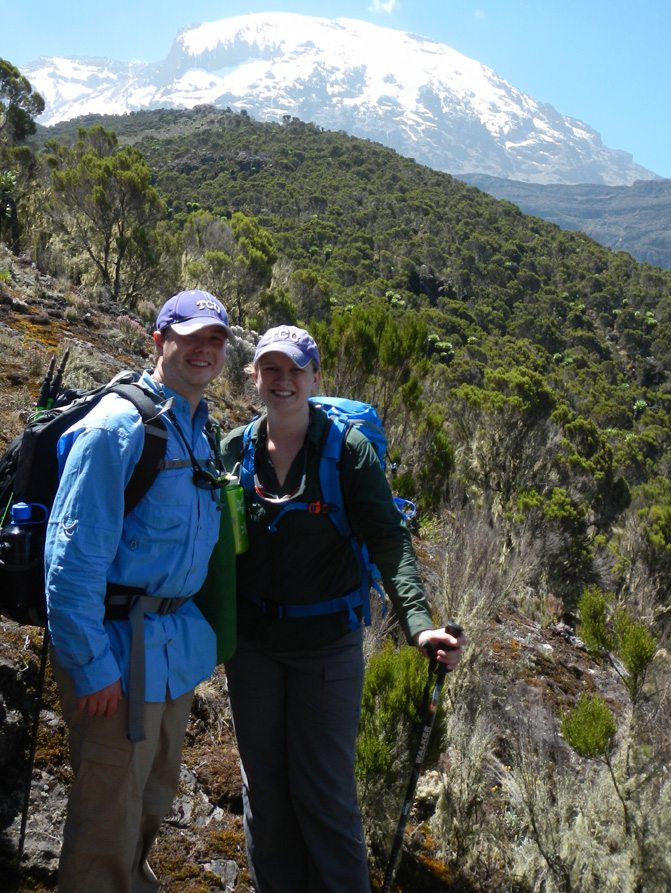 Theresa and Brett pose in an area of vegetation