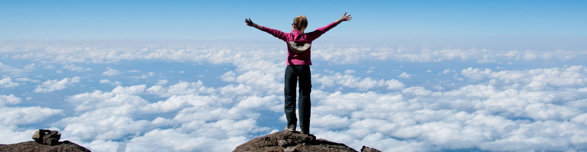 A woman summits Kilimanjaro