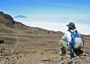 Trekker viewing the clouds from Kilimanjaro