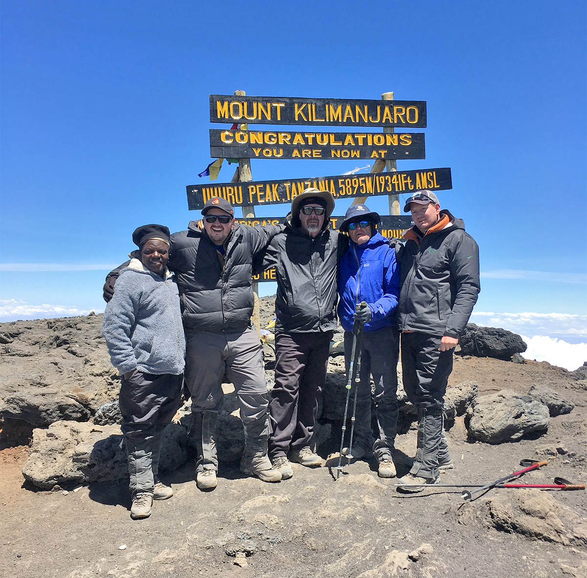 80 year old John at the summit of Mt Kilimanjaro