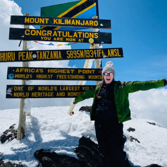 thomson staffer at summit of kilimanjaro