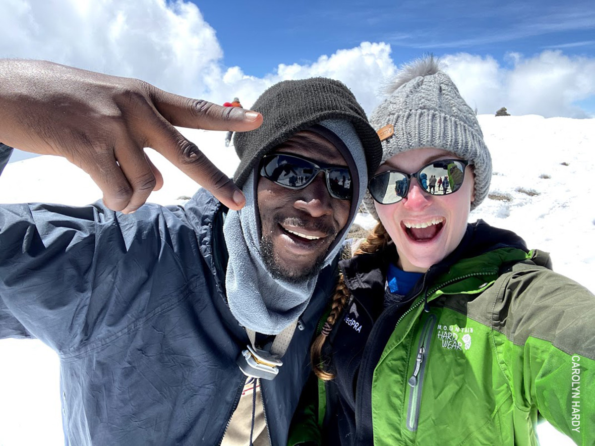 kilimanjaro guide and trekker celebrate at summit