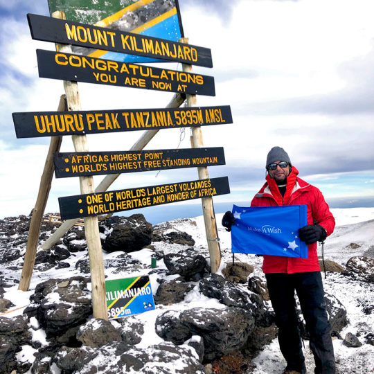 scot farber with make a wish flag on kilimanjaro