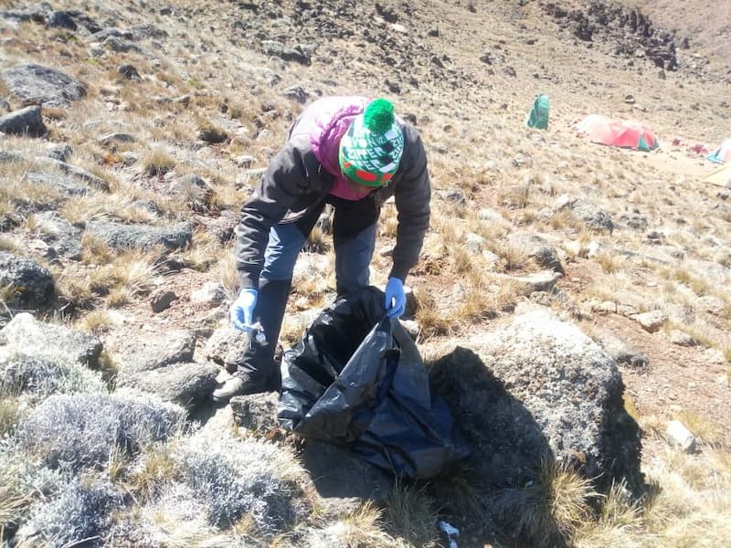 crew cleaning up debris left behind on kili