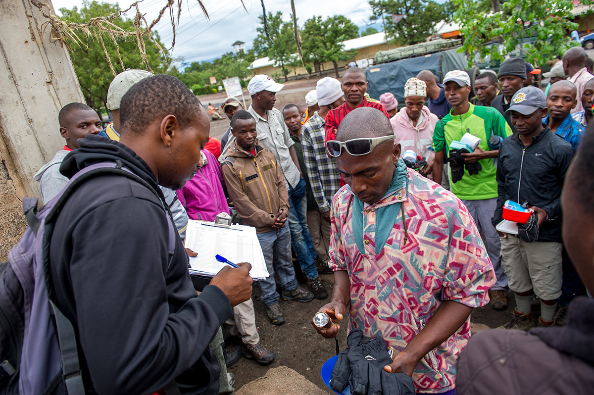 confirming porters are properly outfitted before working on kilimanjaro