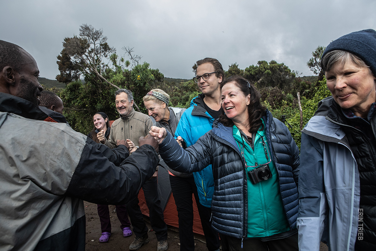 hikers thank porters after kilimanjaro trek