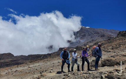 trekkers in alpine desert zone on kilimanjaro