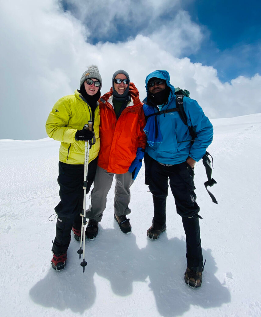 carolyn with kilimanjaro guide and fellow trekker near uhuru peak