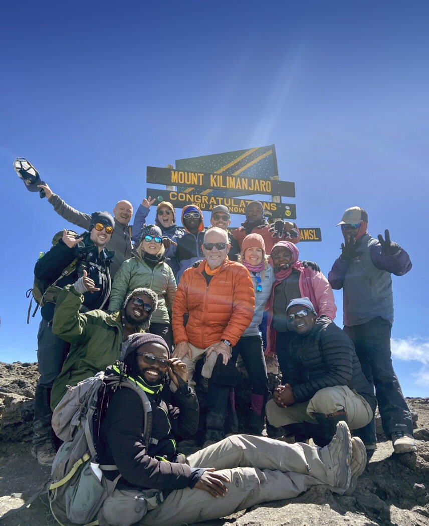 thomson trekkers at kilimanjaro summit with guides and porters