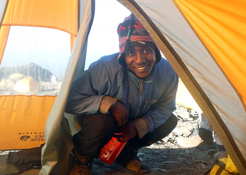 thomson porter delivering water to tent on kilimanjaro