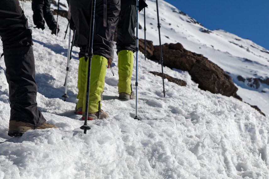 closeup of feet trekking though snow on mount kilimanjaro