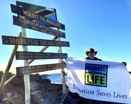 organ transplant recipient at the summit of Kilimanjaro with a Donate Life flag
