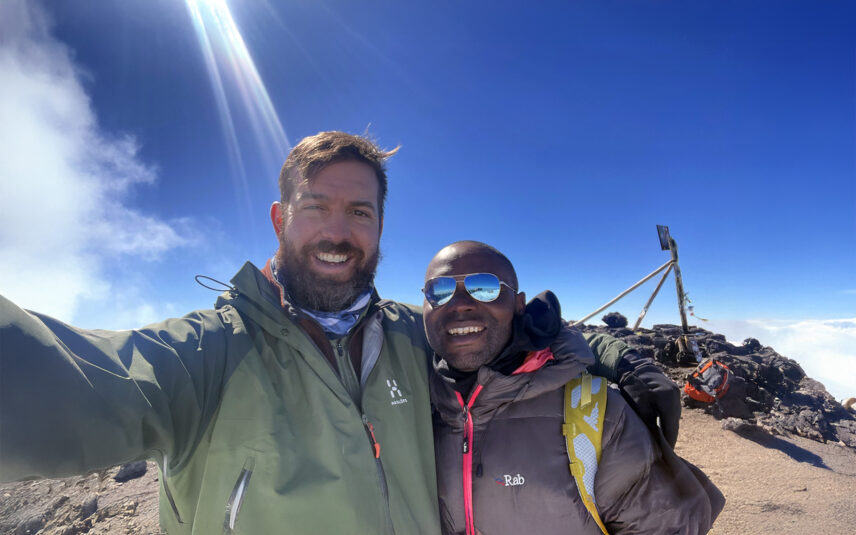kilimanjaro guide gabriel with thomson staffer lewis at uhuru peak summit