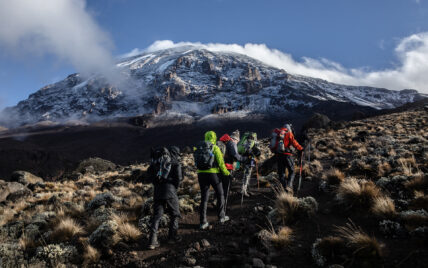 trekkers hiking towards kilimanjaro summit