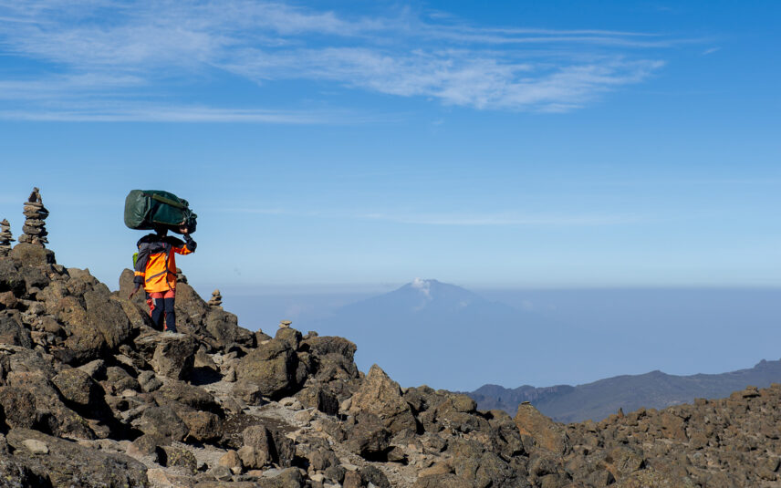 kilimanjaro porter wearing thomson treks uniform