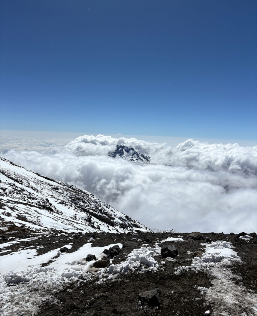 clouds envelope mount mawenzi as viewed from stella point on mount kilimanjaro