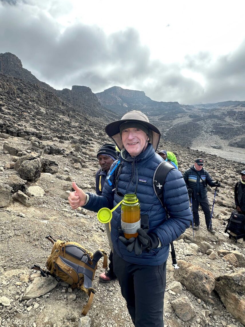 bob taking a break to sip water from his nalgene on kilimanjaro