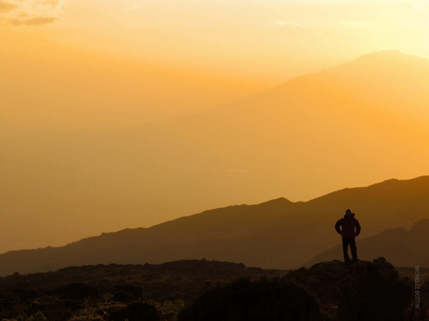 trekker at kilimanjaro shira camp at sunset